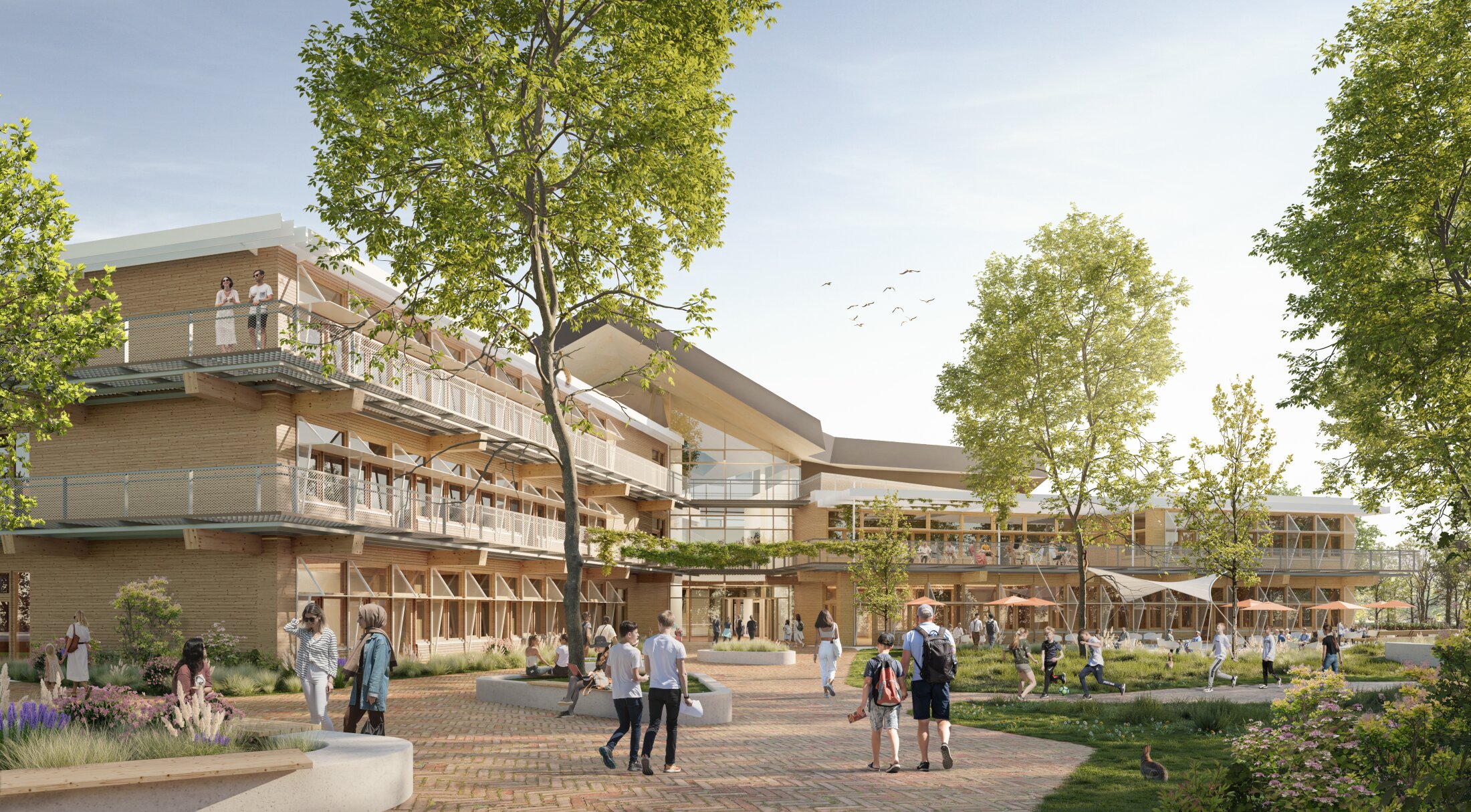 Project by Behnisch Architekturbuero, Gotthard-M&uuml;ller-School Bernhausen. A modern school building with an angular roof and glass facade; students stand and walk in a large paved courtyard. There are several bicycle parking areas in front of the building.
