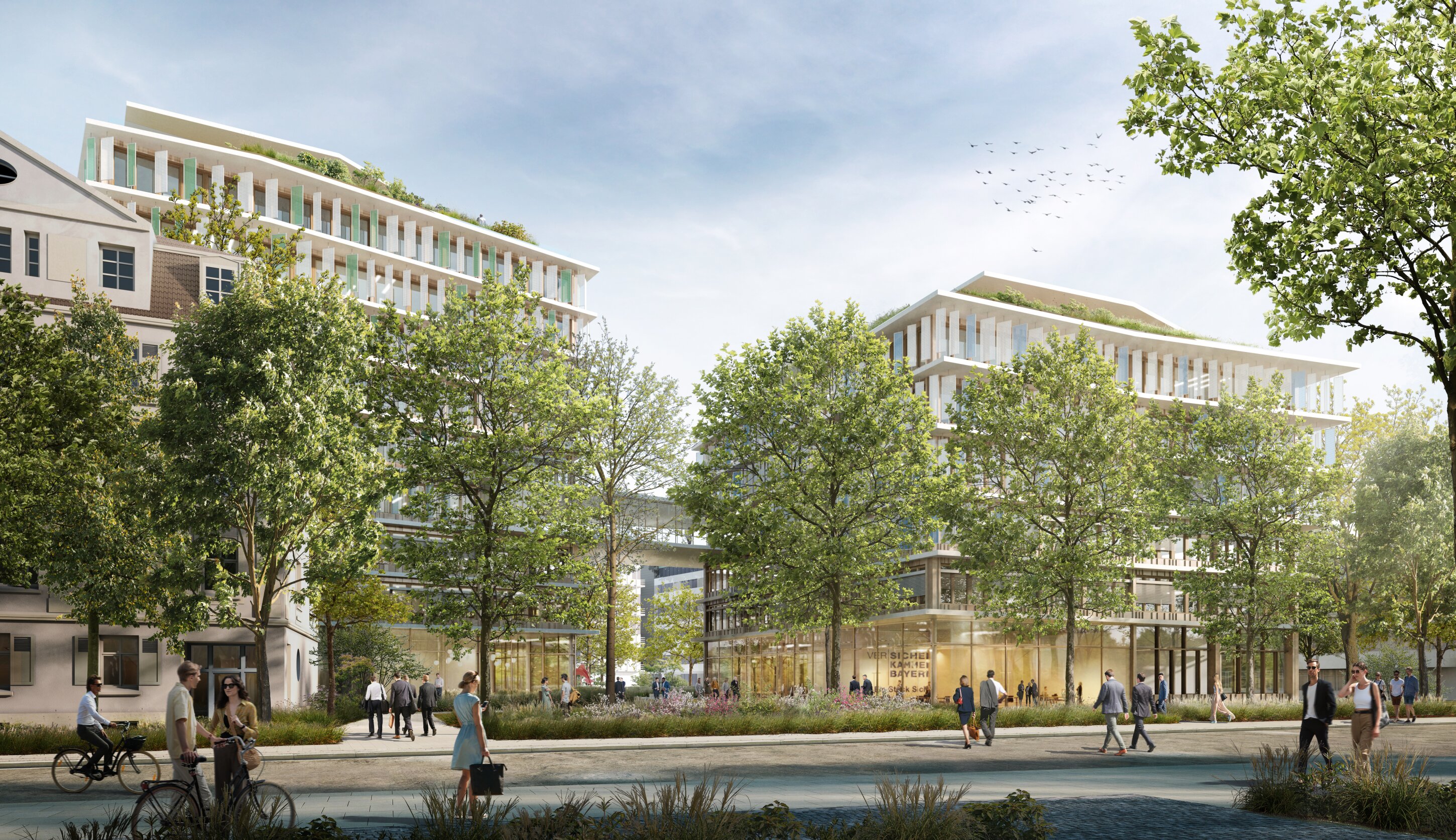 Project by Behnisch Architekturbuero, Campus Giesing. Modern office buildings with glass facades behind a tree-lined street, with people walking and cycling in a landscaped urban setting.