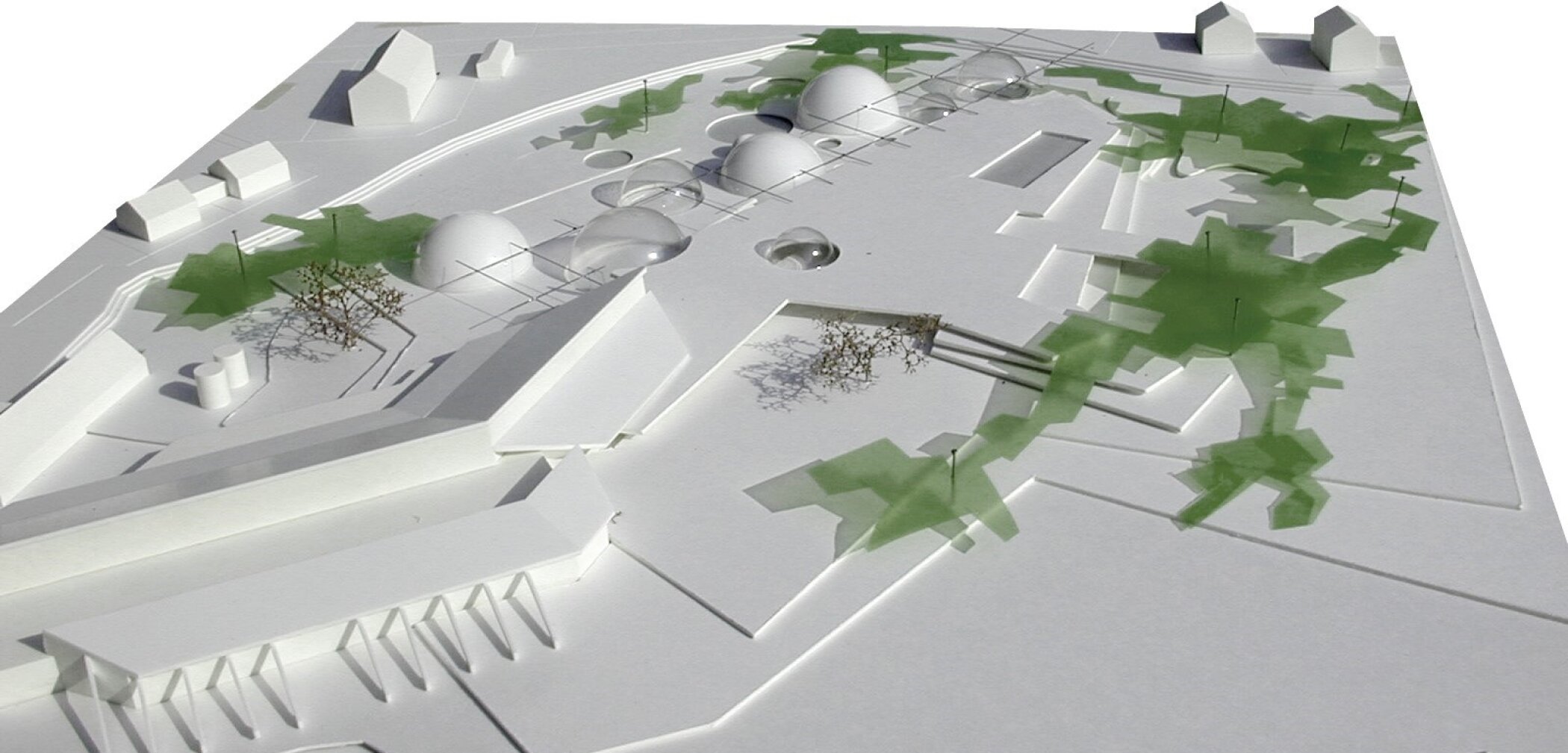 Project by Behnisch Architekturbuero, Thermal Spa Bad Aibling. White site model with low buildings and several domed structures, surrounded by abstract green areas indicating trees and landscape paths.