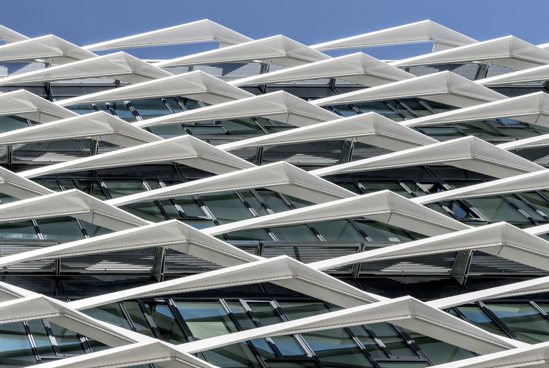 Project by Behnisch Architekturbuero, adidas ARENA. Grid-like facade features it is a specially designed sun protection and shading system.