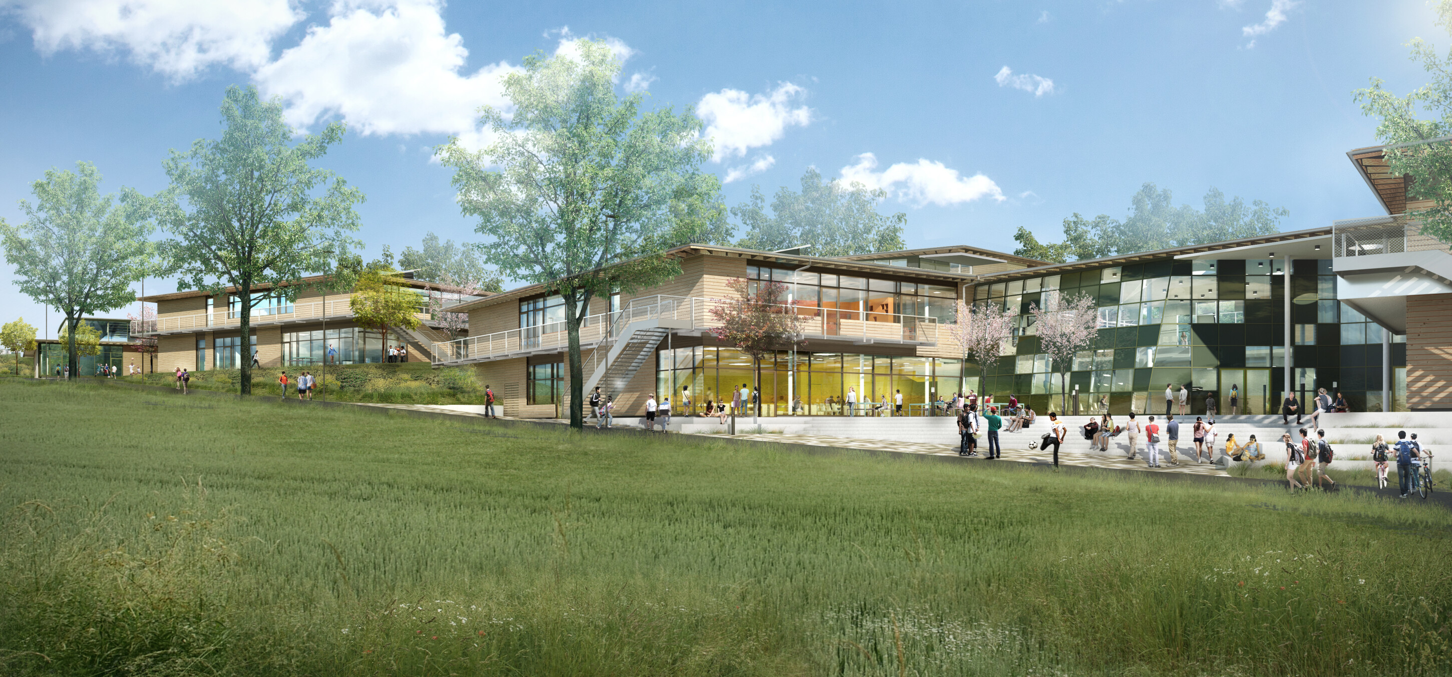 Project by Behnisch Architekturbuero, Public Secondary School Neuburg an der Donau. Modern school buildings with wood and glass facades set on a grassy slope, with students walking and gathering outside under trees.
