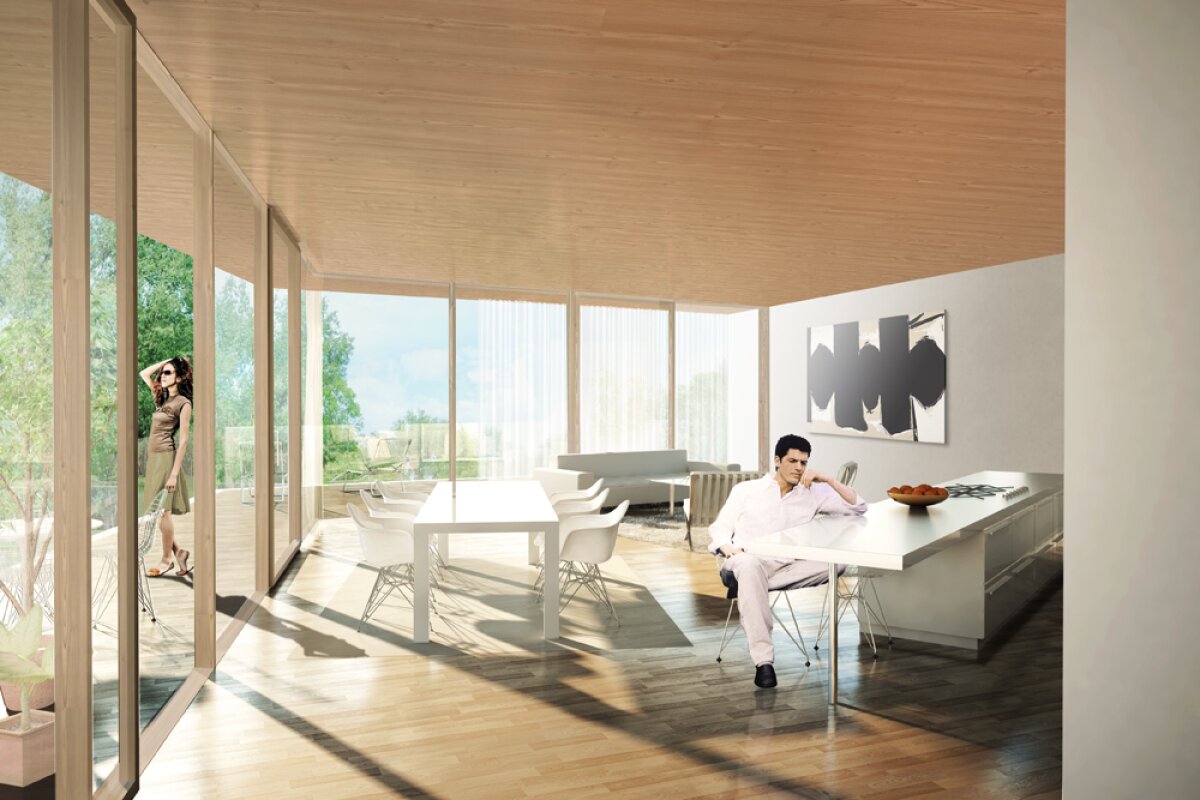 Project by Behnisch Architekturbuero, Smart material houses. Bright open-plan living and dining area with floor-to-ceiling windows, wooden ceiling, modern furniture, and people seated and standing nearby.